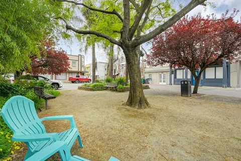 a view of house with a yard and sitting area