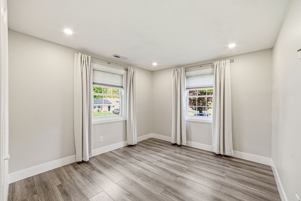 157 Errol Road Brockton, MA 02302 - Photo 27 of 34 an empty room with wooden floor and windows