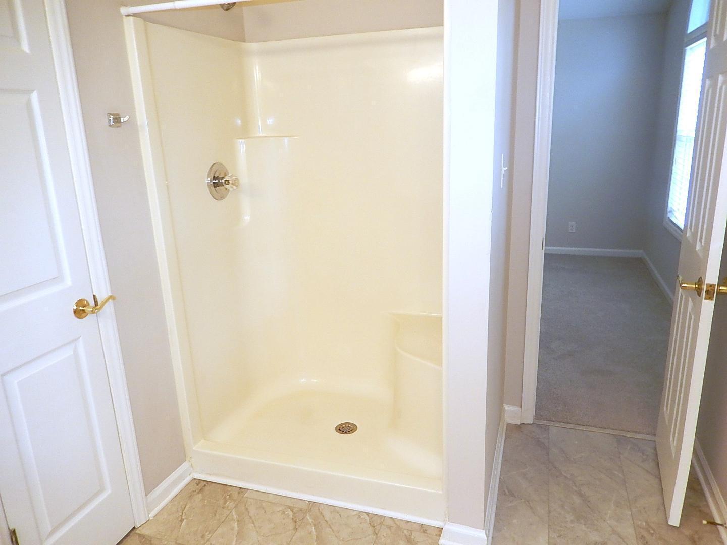 211 Bridgepath Drive Cary, NC 27513 - Photo 20 of 26 a bathroom with a glass shower door