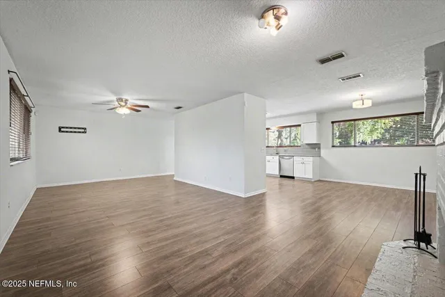 a view of a kitchen with a sink and a window