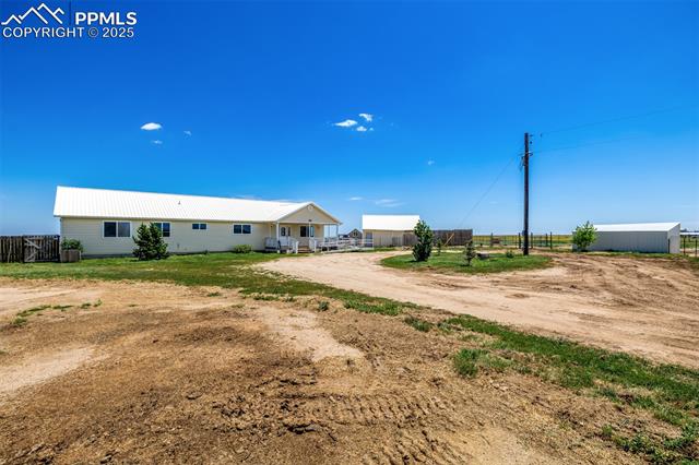 6065 Mulberry Road Calhan, CO 80808 - Photo 4 of 45 View of front of home featuring a metal roof and driveway