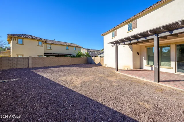 a view of a house with backyard and road