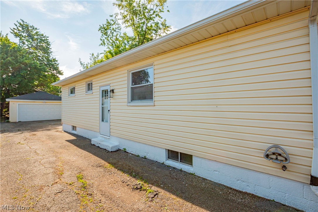 421 Hillman Road Akron, OH 44312 - Photo 27 of 27 View of home's exterior featuring an outdoor structure and a garage