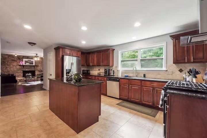 230 Chaffin Ridge Trace Roswell, GA 30075 - Photo 3 of 20 a kitchen with stainless steel appliances granite countertop a stove a sink dishwasher a refrigerator and a refrigerator