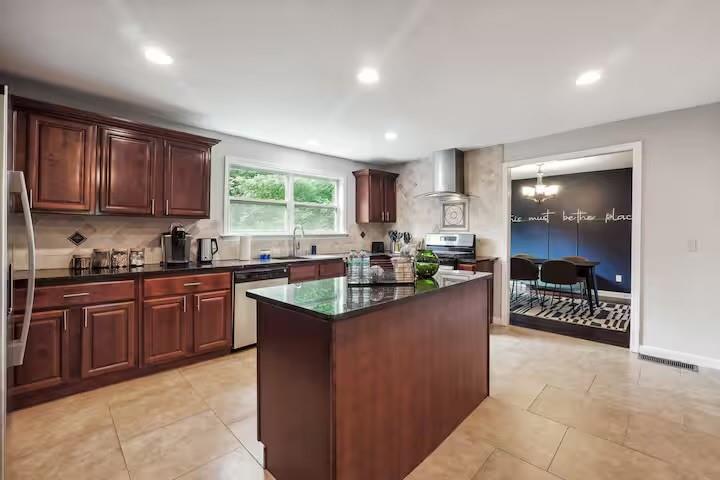 230 Chaffin Ridge Trace Roswell, GA 30075 - Photo 4 of 20 a kitchen with stainless steel appliances granite countertop a stove a sink a oven a dining table and chairs