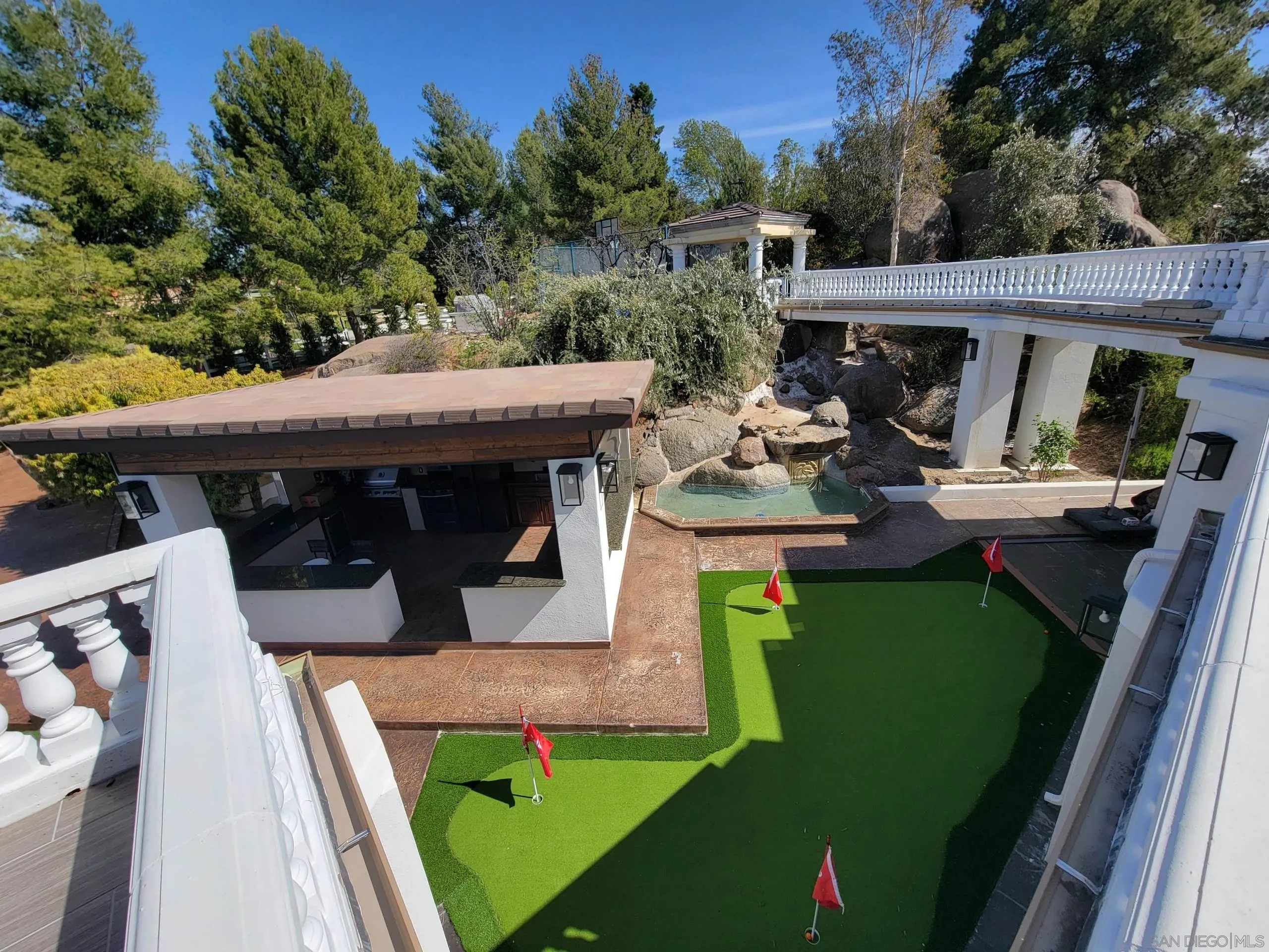 2715 Via Chinarros Alpine, CA 91901 - Photo 4 of 8 a view of a patio with table and chairs with wooden floor and fence