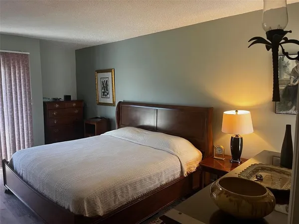 a bedroom with a bed and a lamp