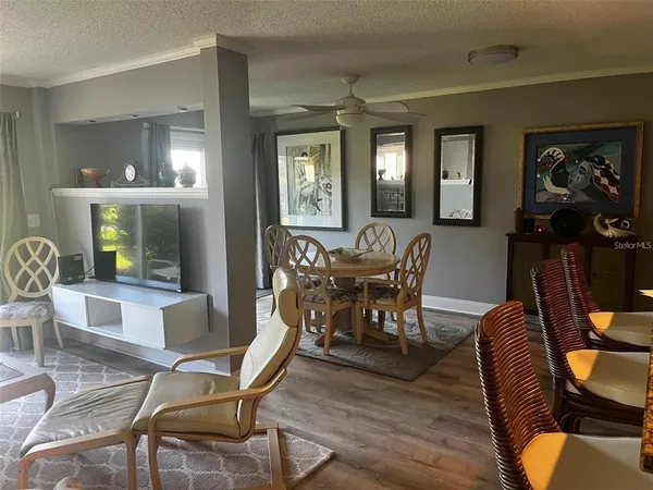 a dining room with furniture and wooden floor