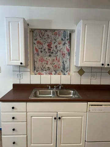 a kitchen with a sink and cabinets