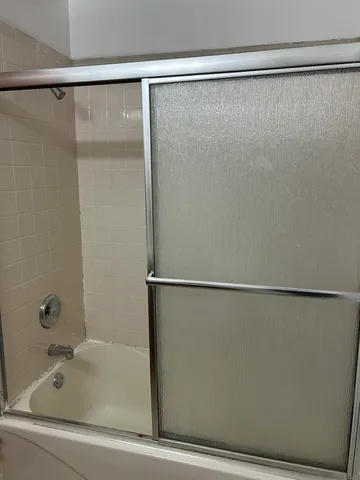 a bathroom with a shower and a bath tub