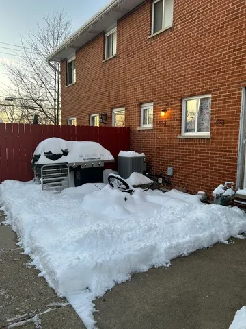 a backyard of a house with a barbeque oven and outdoor seating