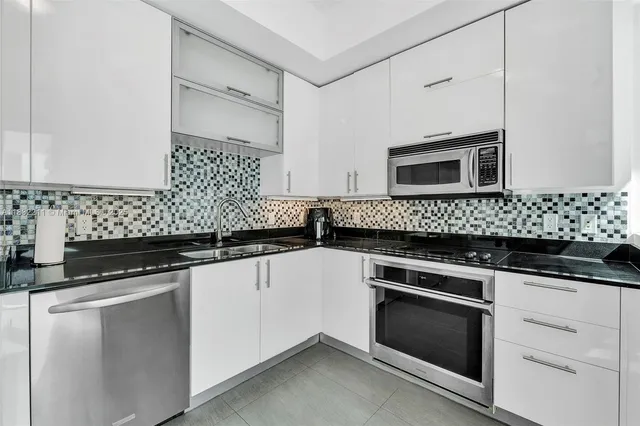 a kitchen with a refrigerator stove and microwave
