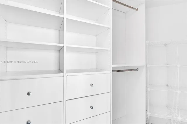 a view of an empty room with closet