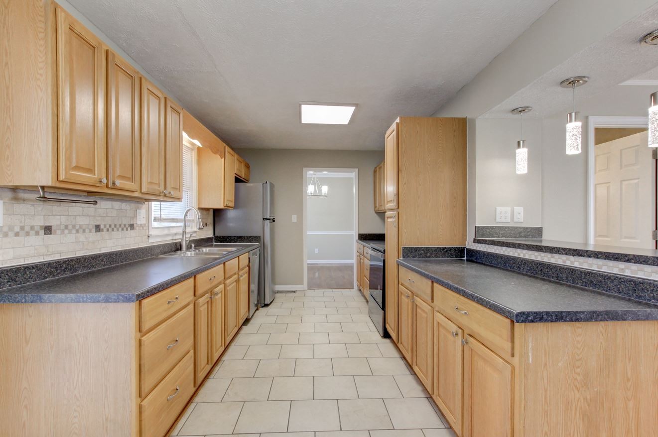 1105 Bark Ridge Circle Hopkinsville, KY 42240 - Photo 12 of 29 a large kitchen with stainless steel appliances granite countertop a sink and cabinets