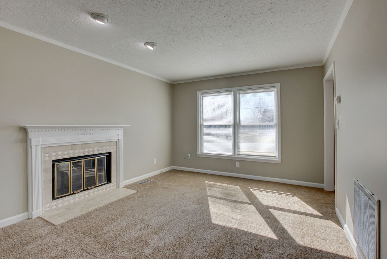 1105 Bark Ridge Circle Hopkinsville, KY 42240 - Photo 15 of 29 a big room with windows and a fireplace