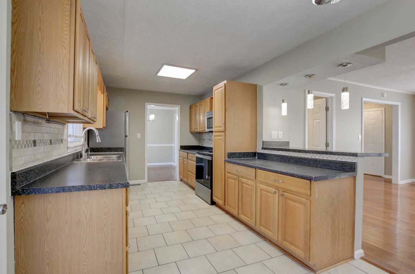 1105 Bark Ridge Circle Hopkinsville, KY 42240 - Photo 16 of 29 a kitchen with stainless steel appliances granite countertop a sink and a stove