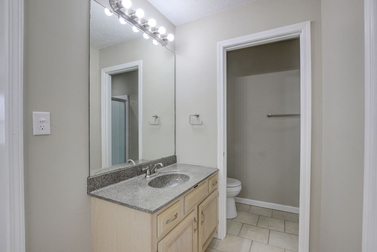 1105 Bark Ridge Circle Hopkinsville, KY 42240 - Photo 24 of 29 a bathroom with a granite countertop sink and a mirror