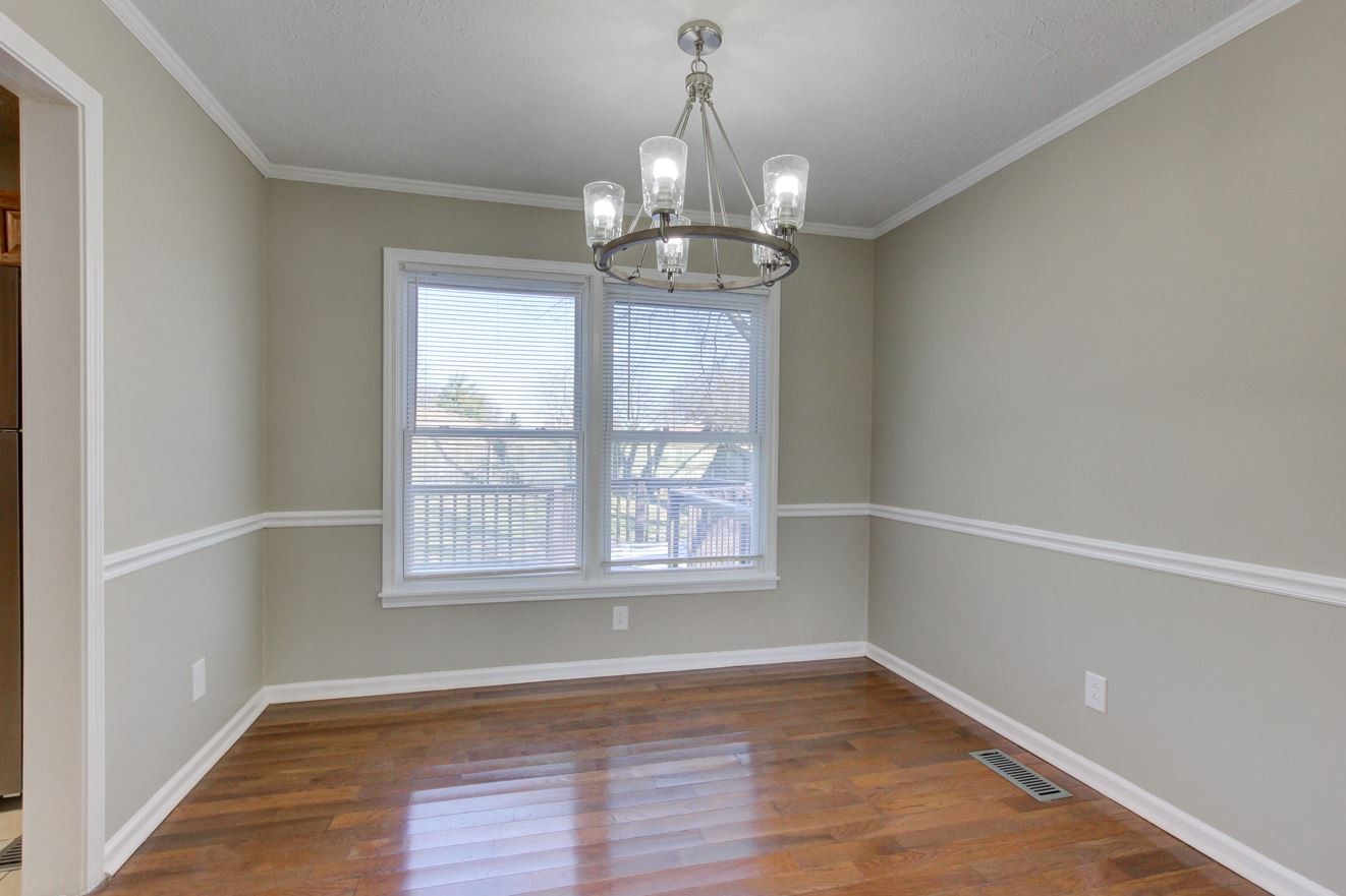 1105 Bark Ridge Circle Hopkinsville, KY 42240 - Photo 8 of 29 a view of an empty room with wooden floor and a window
