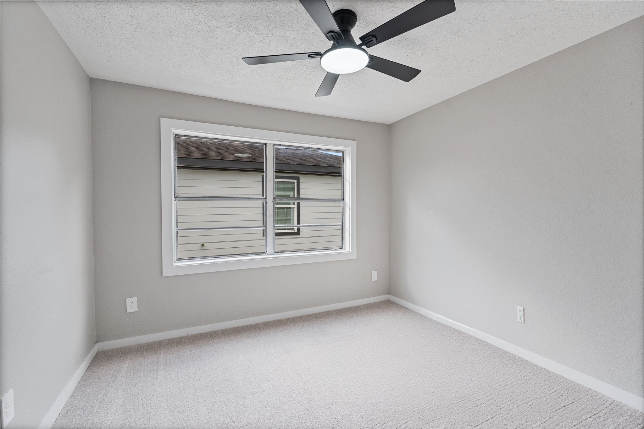 2007 Vince Street Pasadena, TX 77502 - Photo 18 of 29 an empty room with a window and a fan