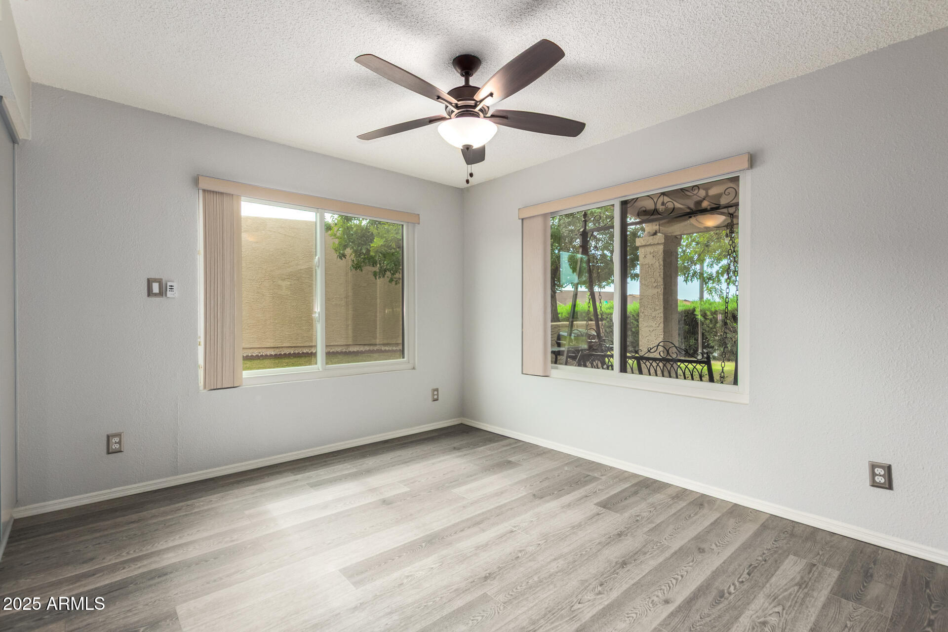716 South Privet Way Mesa, AZ 85208 - Photo 17 of 40 a view of an empty room with wooden floor and a window