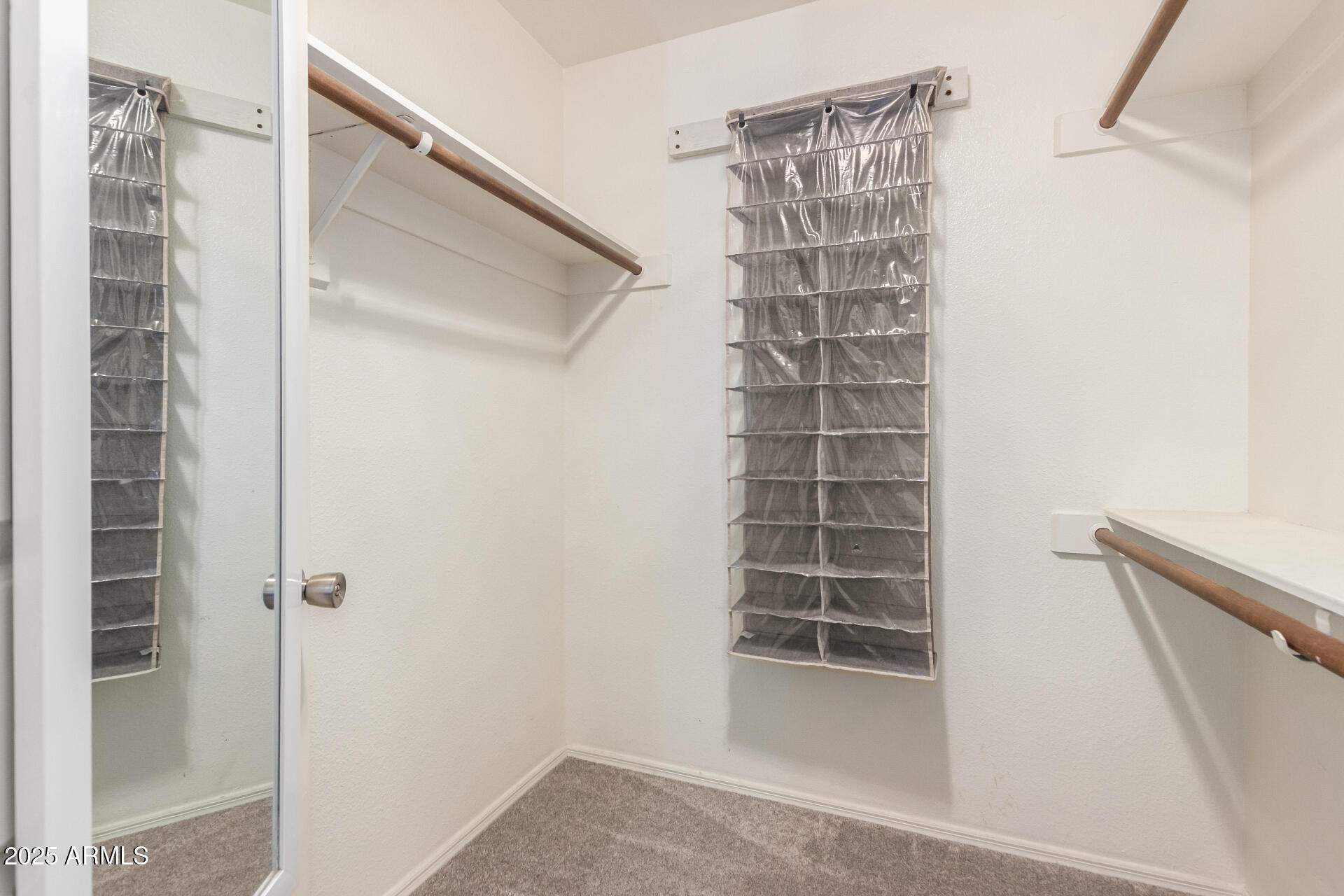 716 South Privet Way Mesa, AZ 85208 - Photo 20 of 40 a view of walk in closet with empty racks