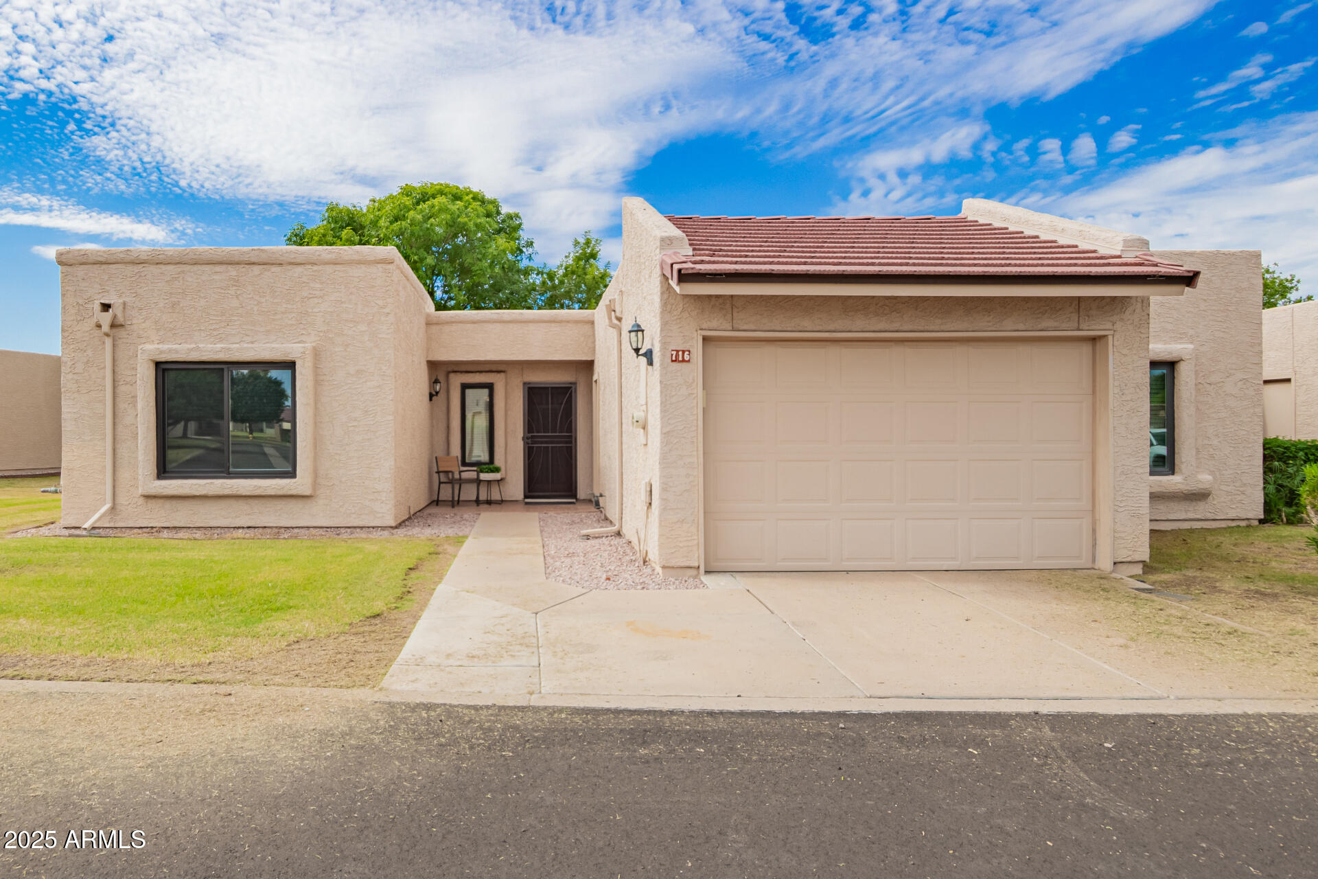 716 South Privet Way Mesa, AZ 85208 - Photo 2 of 40 a view of a house with a garage and yard