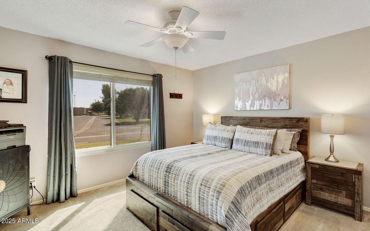 716 South Privet Way Mesa, AZ 85208 - Photo 26 of 40 a bedroom with a large bed and a chandelier