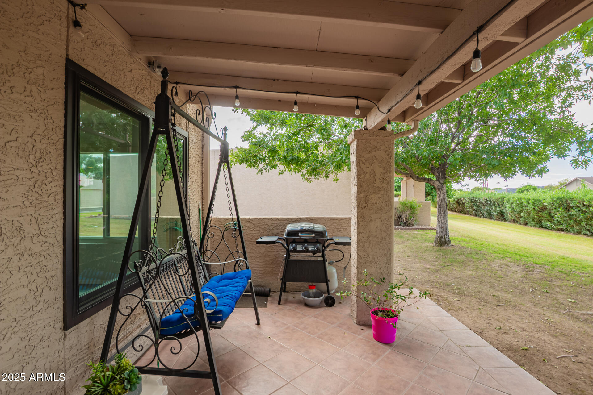 716 South Privet Way Mesa, AZ 85208 - Photo 36 of 40 a view of a patio with table and chairs potted plants and floor to ceiling window