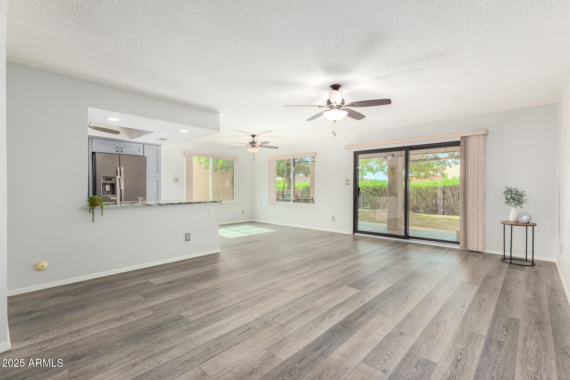 716 South Privet Way Mesa, AZ 85208 - Photo 6 of 40 a view of an empty room with a window and wooden floor