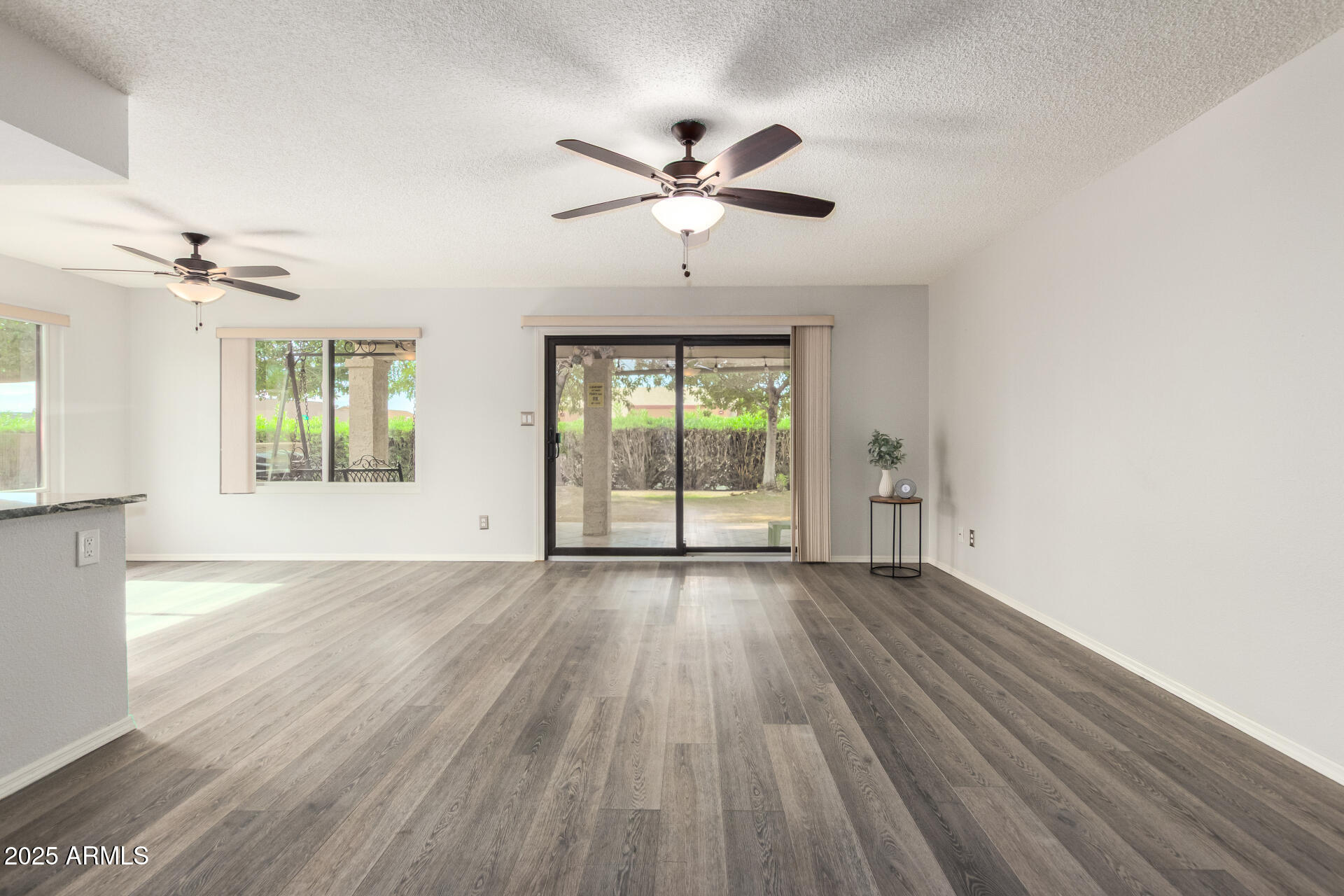 716 South Privet Way Mesa, AZ 85208 - Photo 8 of 40 a view of an empty room with a window and wooden floor
