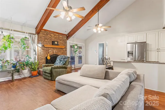 a kitchen with stainless steel appliances a refrigerator a stove a sink and chairs