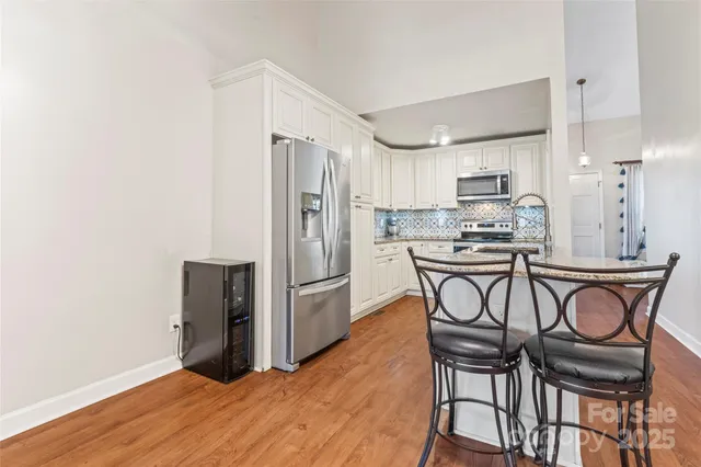 a kitchen with stainless steel appliances granite countertop a sink and stove