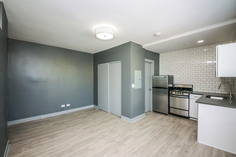 944 West Montrose Avenue, Unit 309 Chicago, IL 60613 - Photo 4 of 9 a kitchen with stainless steel appliances granite countertop a refrigerator and a stove top oven