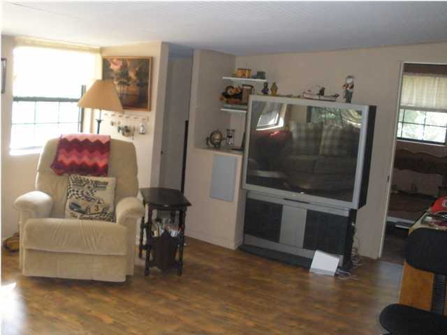 240 Wesley Road DeFuniak Springs, FL 32433 - Photo 15 of 25 a living room with furniture and a flat screen tv