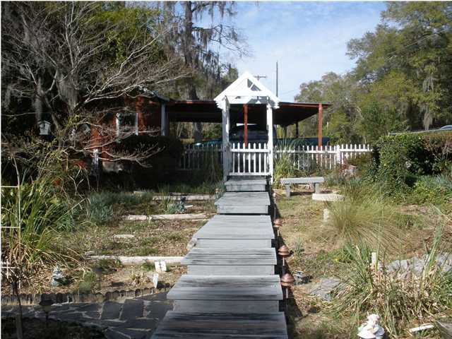 240 Wesley Road DeFuniak Springs, FL 32433 - Photo 2 of 25 a view of a house with entrance door and balcony