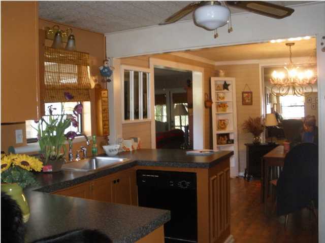 240 Wesley Road DeFuniak Springs, FL 32433 - Photo 7 of 25 a kitchen with stainless steel appliances granite countertop a sink counter space and living room view