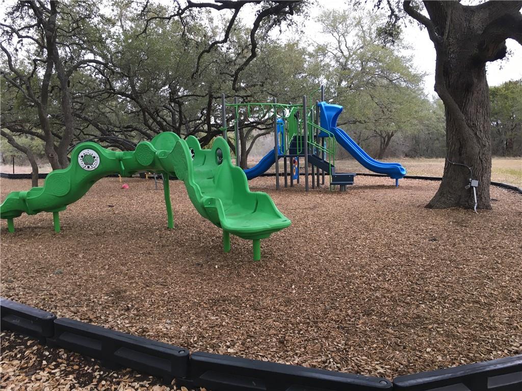 4615 Tello Path Austin, TX 78749 - Photo 26 of 29 A vibrant playground set amidst mature trees, offering endless outdoor enjoyment.