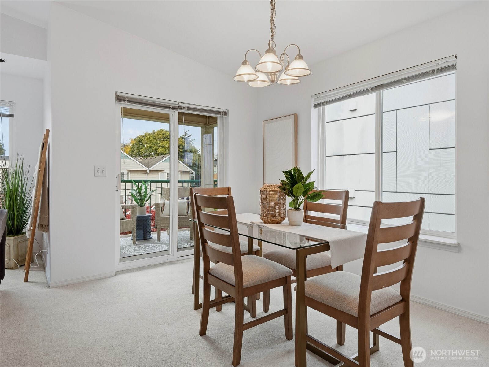 1733 Northwest 59th Street, Unit 301 Seattle, WA 98107 - Photo 11 of 35 a view of a dining room with furniture and a chandelier