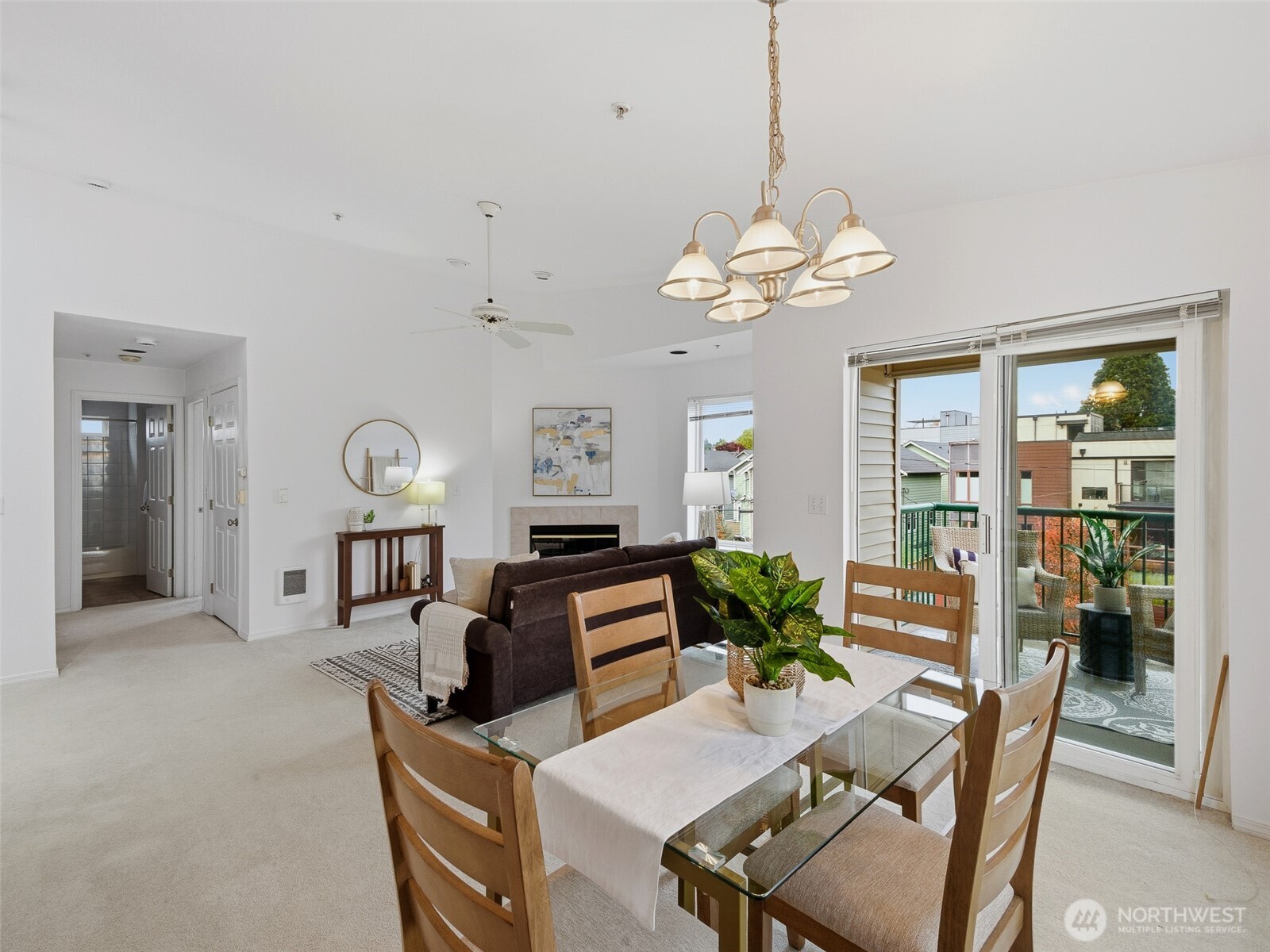 1733 Northwest 59th Street, Unit 301 Seattle, WA 98107 - Photo 12 of 35 a view of a dining room with furniture a chandelier and large windows