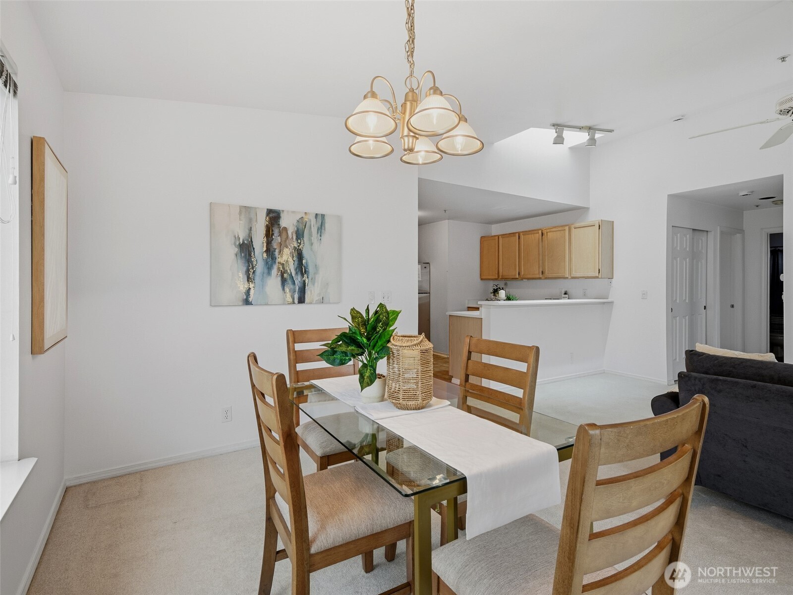 1733 Northwest 59th Street, Unit 301 Seattle, WA 98107 - Photo 13 of 35 a dining room with wooden floor a chandelier a wooden table and chairs