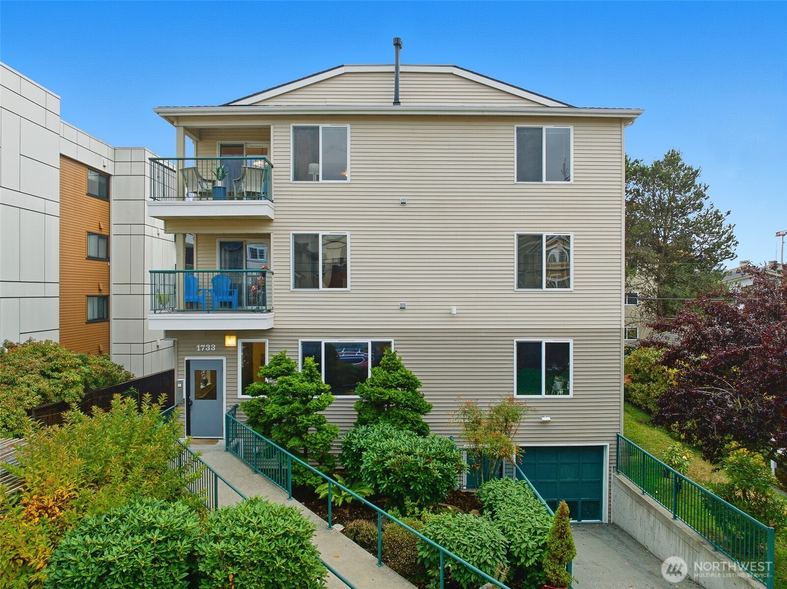 1733 Northwest 59th Street, Unit 301 Seattle, WA 98107 - Photo 2 of 35 a front view of a house with a yard