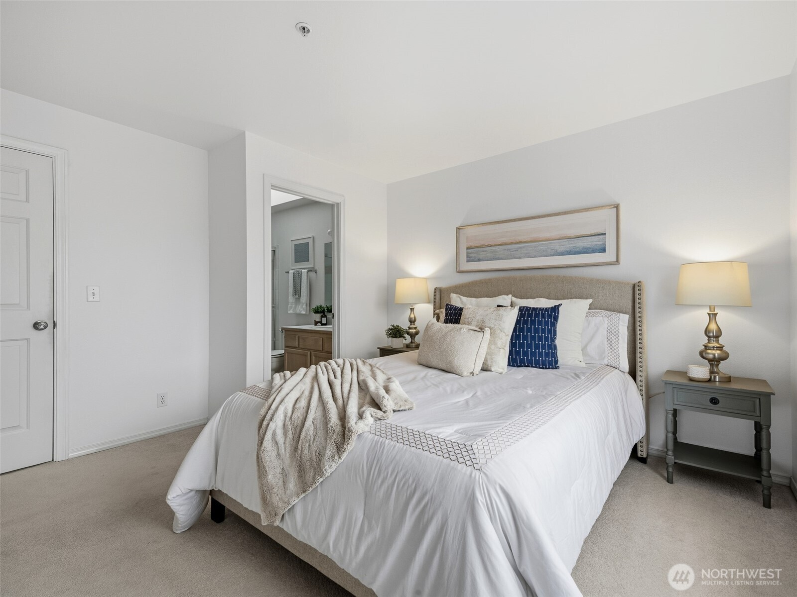 1733 Northwest 59th Street, Unit 301 Seattle, WA 98107 - Photo 24 of 35 a bedroom with a bed and a lamp