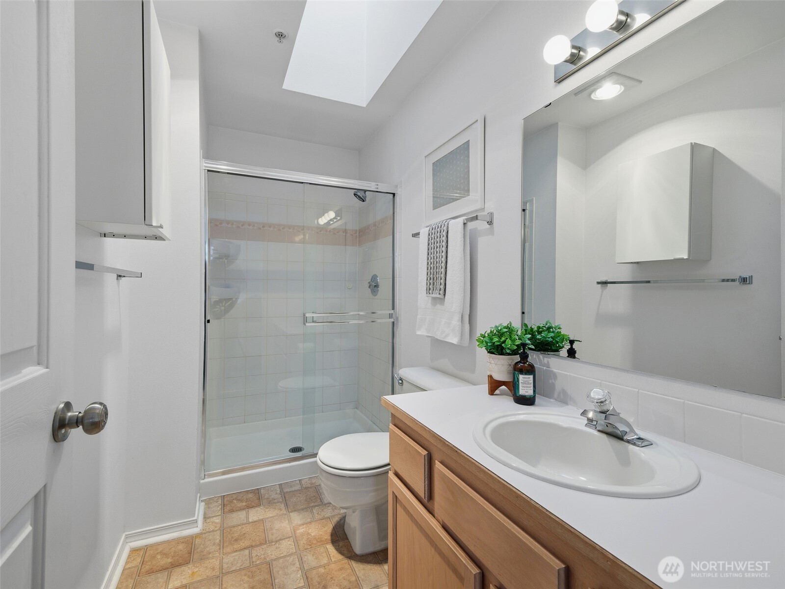 1733 Northwest 59th Street, Unit 301 Seattle, WA 98107 - Photo 26 of 35 a bathroom with a sink toilet and shower