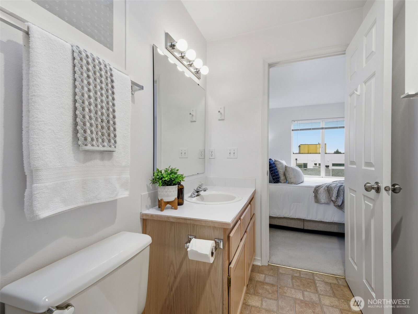 1733 Northwest 59th Street, Unit 301 Seattle, WA 98107 - Photo 27 of 35 a en suite spacious bathroom with a tub sink and mirror