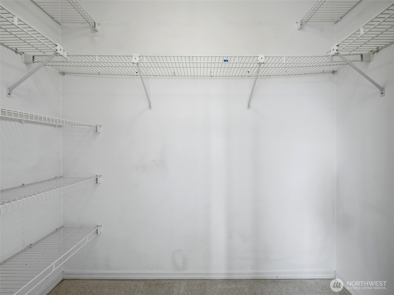 1733 Northwest 59th Street, Unit 301 Seattle, WA 98107 - Photo 28 of 35 a view of a room with racks on the wall