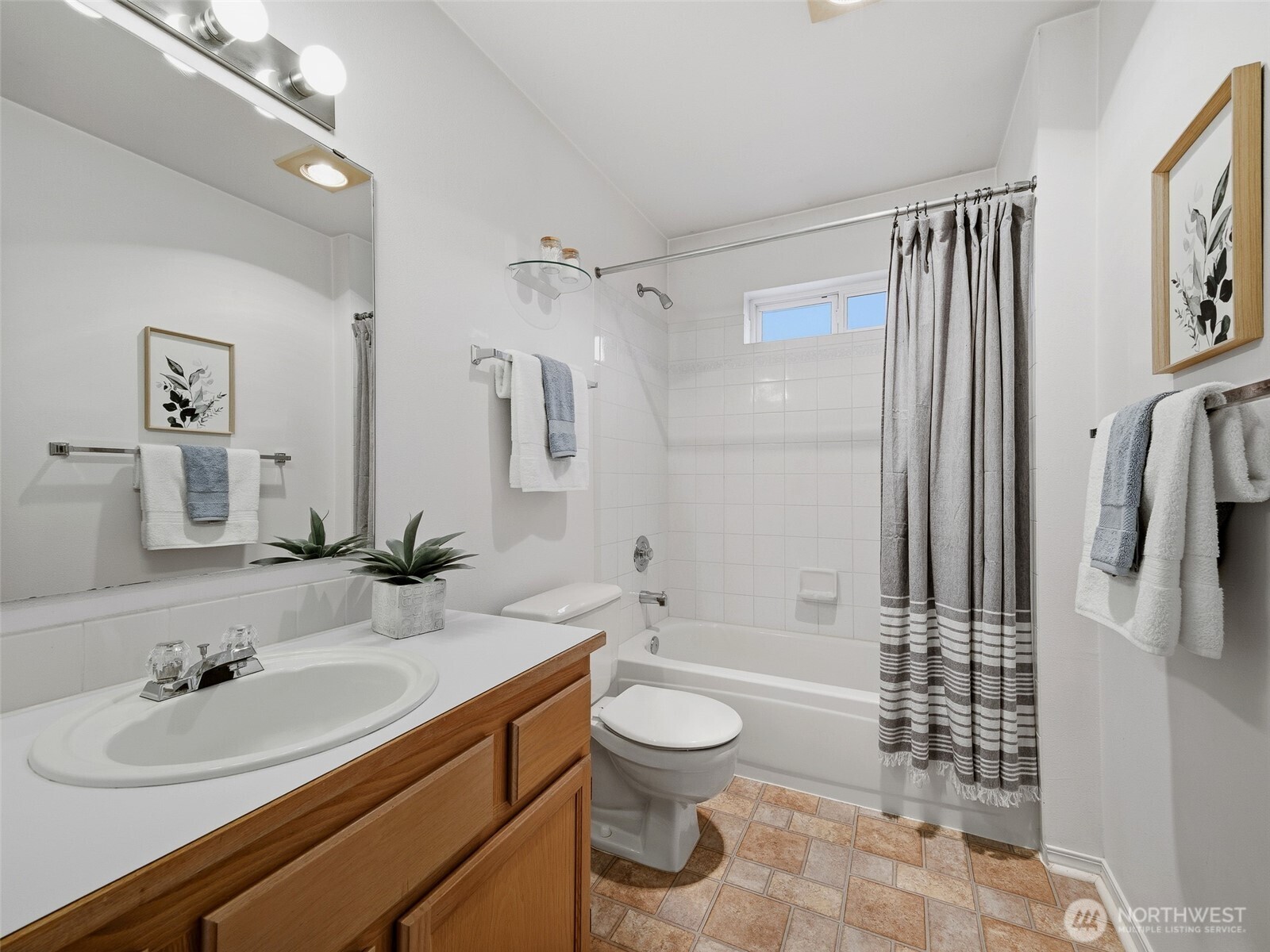 1733 Northwest 59th Street, Unit 301 Seattle, WA 98107 - Photo 31 of 35 a bathroom with a sink a toilet and shower