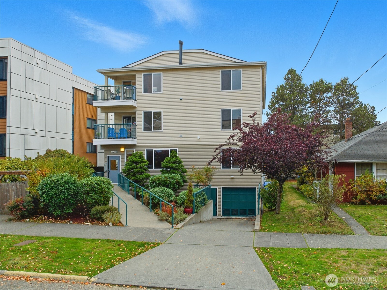1733 Northwest 59th Street, Unit 301 Seattle, WA 98107 - Photo 33 of 35 a front view of a house with a yard