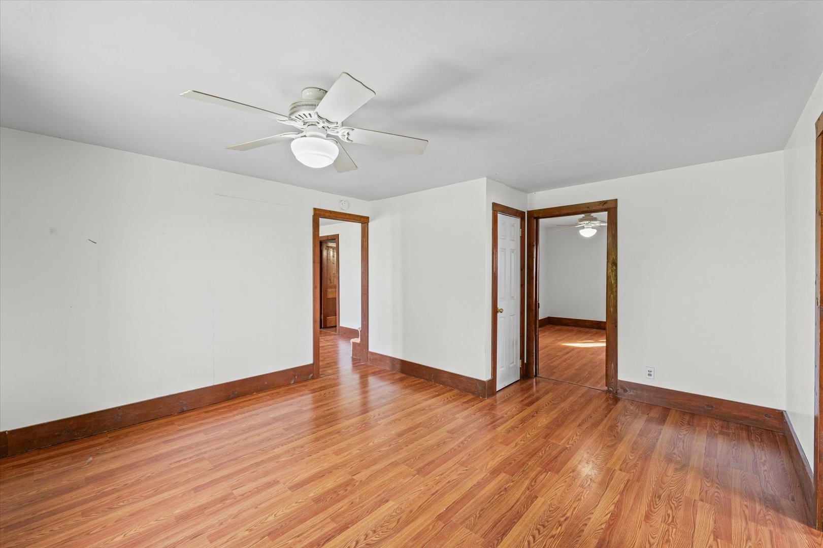 104 Allen Street Allerton, IL 61810 - Photo 14 of 33 an empty room with wooden floor fan and windows