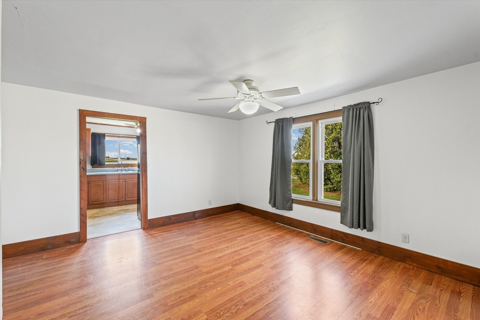 104 Allen Street Allerton, IL 61810 - Photo 15 of 33 wooden floor in an empty room with a window