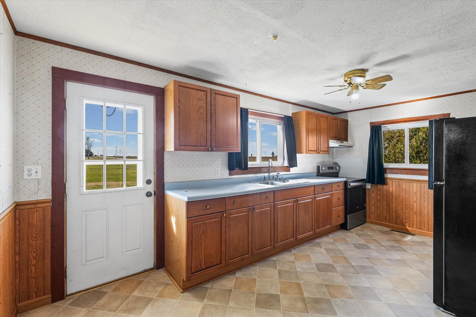 104 Allen Street Allerton, IL 61810 - Photo 9 of 33 a large kitchen with kitchen island granite countertop a refrigerator a stove a sink and dishwasher with wooden floor